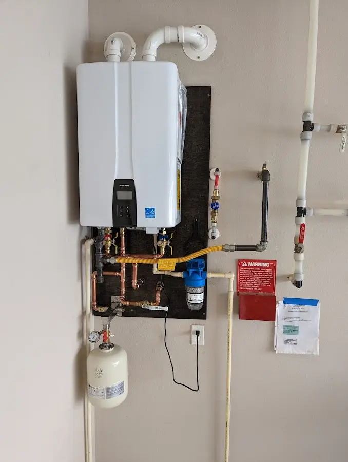 Professional plumber installing copper piping in a Shawnee home